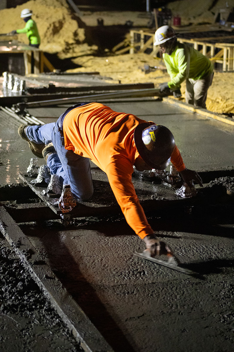 worker spreading concrete